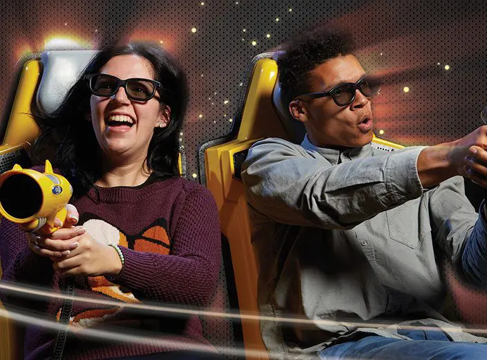 Riders in 3D glasses aim laser blasters on Chaos 5D Adventure ride, an interactive 5D experience on Hollywood Boulevard