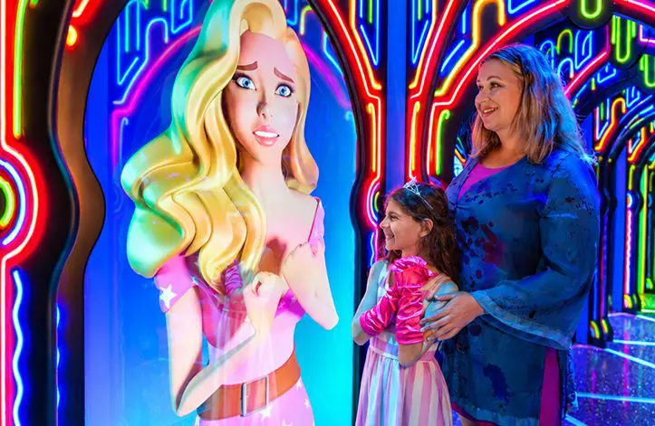 Family laughs while exploring Hannah's Maze of Mirrors, a mirror maze on Hollywood Boulevard in Los Angeles